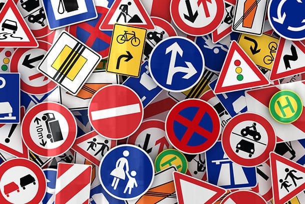 Road signs piled up with many rules
