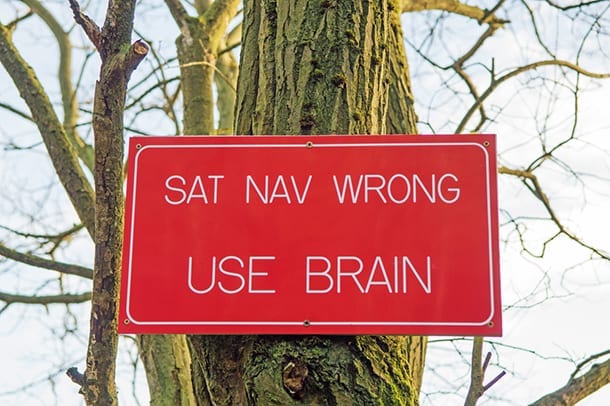 Red sign saying Sat Nav Wrong, Use Brain